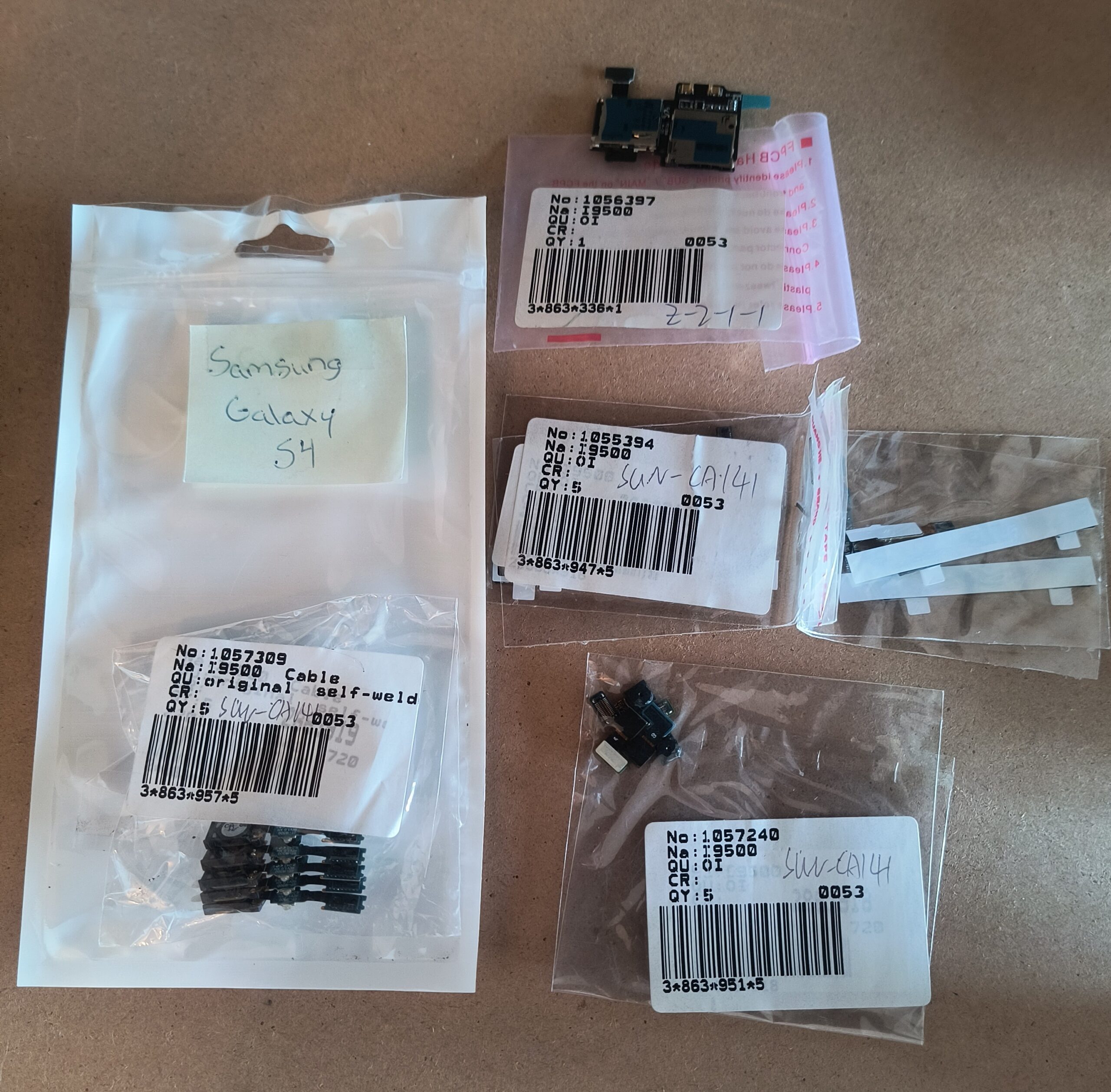 Assorted repair parts lot for Samsung Galaxy S4 - charging port, flex cables, adhesives